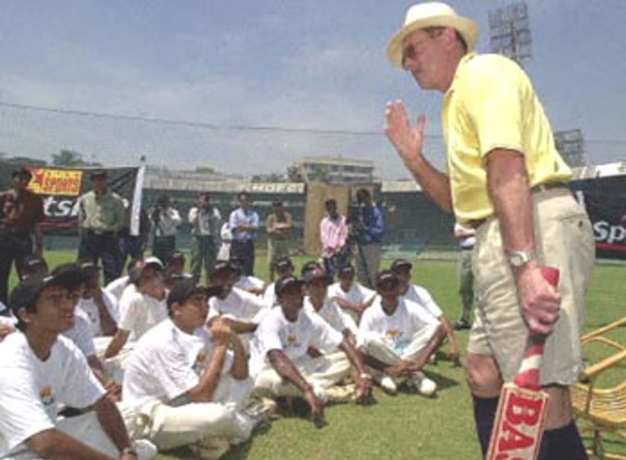 Leading cricket analyst and former British cricket player Geoffrey Boycott (R) gives some useful batting tips to young and promising Indian cricketers 23 September 2000 at the Wankhede stadium in Bombay. Boycott has signed a three-year exclusive contract with ESPN (TV Sports channel) and will make his debut on 'SPORTLINE' an exclusive half-hour Television news programme from 25 September this year.