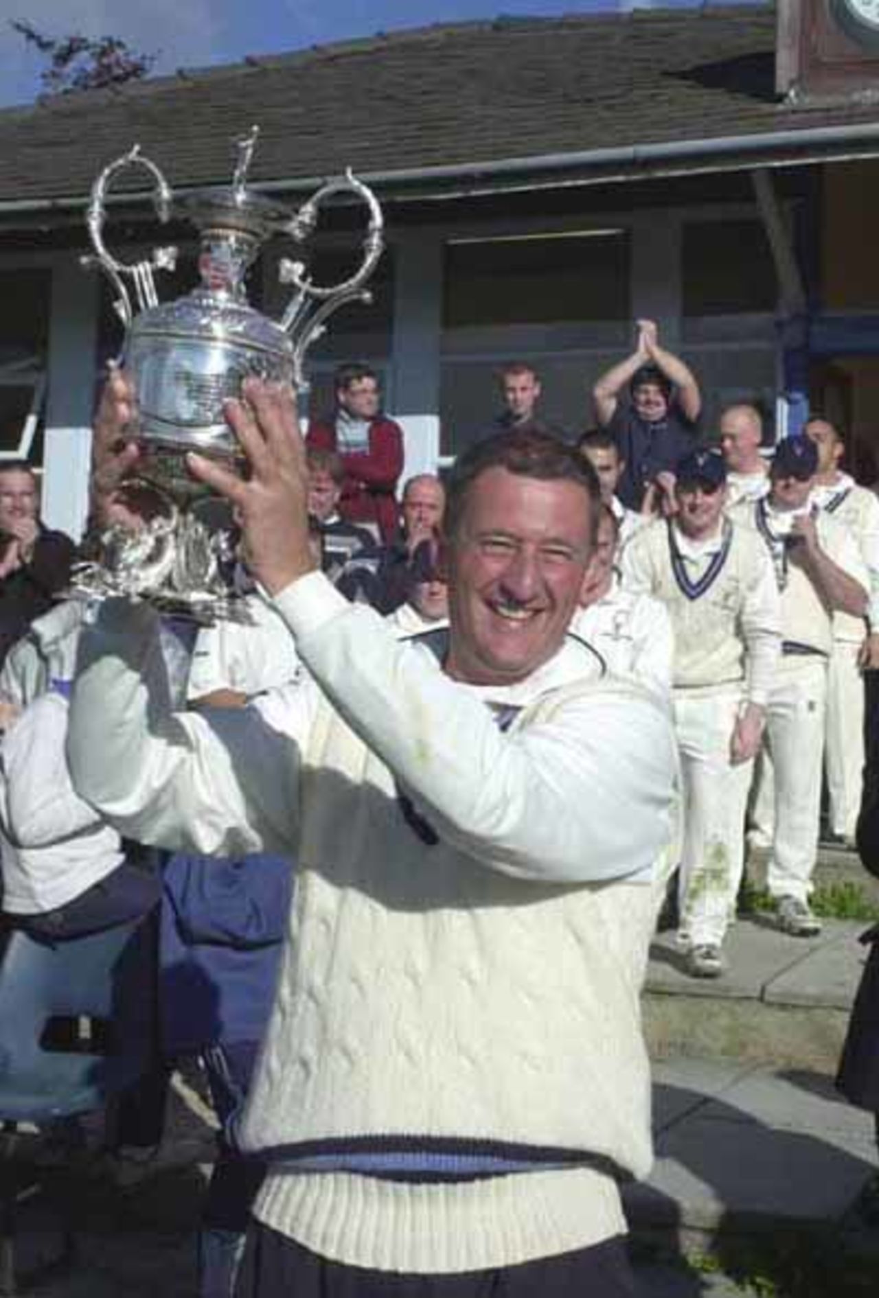 Neal Wilkinson proudly holds the trophy aloft