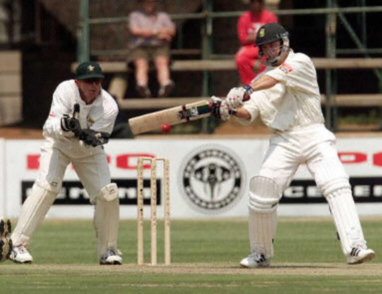Herschelle Gibbs cuts while keeper Andy Flower looks on, Ist Test South Africa v Zimbabwe, 7-11 September 2001, at Harare.