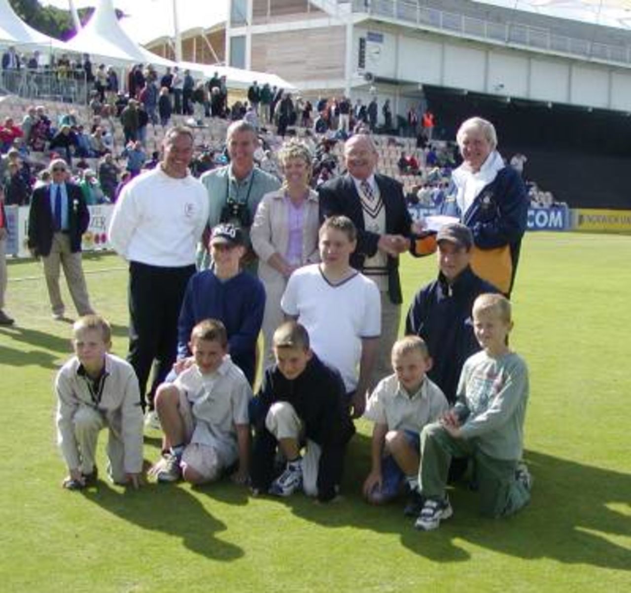 Eversley Colts present Alan Rowe with cheque for Hampshire Youth Development Trust, raised from John Stephenson benefit match, with shared proceeds.