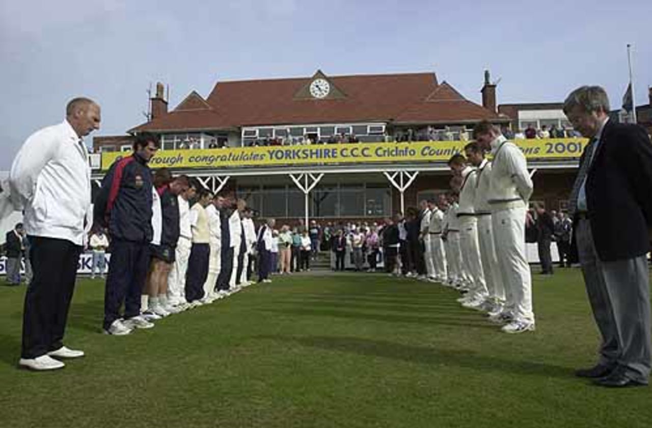 The Essex and Yorkshire teams line up to show their respects for the victims of the American terrorist attacks