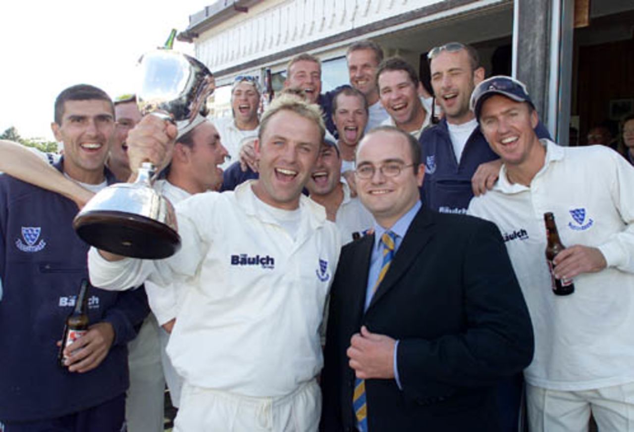 Sussex captain Chris Adams receives the cup from CricInfo's Andrew Hall after winning the second division after the county championship match against Gloucestershire at Hove
