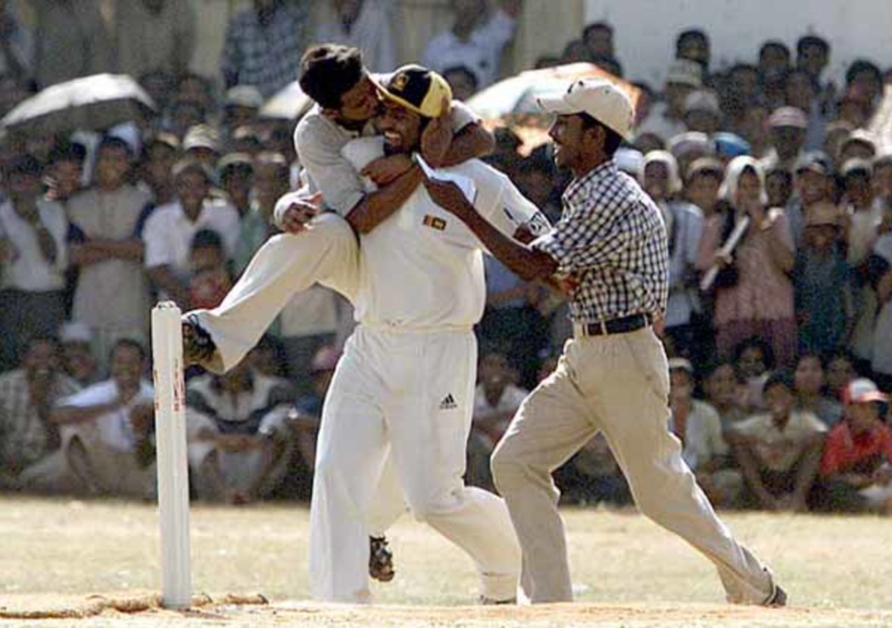 A Tamil cricket fan hugs Sri Lankan bowler Muttiah Muralitharan during a cricket match at Jaffna Central College ground in Sri Lanka's northern city of Jaffna on September 1, 2002. Muralitharan and some other national Sri Lankan cricketers arrived in Jaffna after crossing Tamil Tiger rebel held Vanni area in Saturday to play a friendly cricket match against a Jaffna district side.