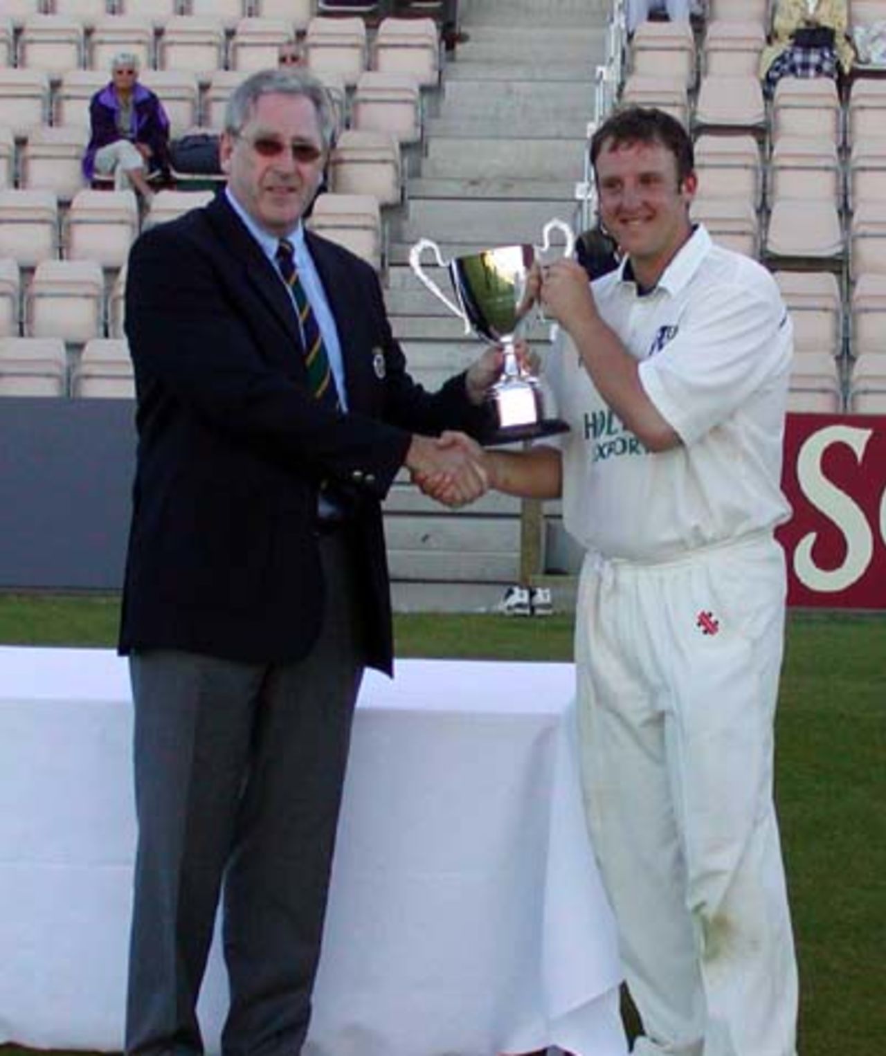 James Tredwell receives the ECB 2ndXI Trophy from Hampshire chairman Rod Bransgrove