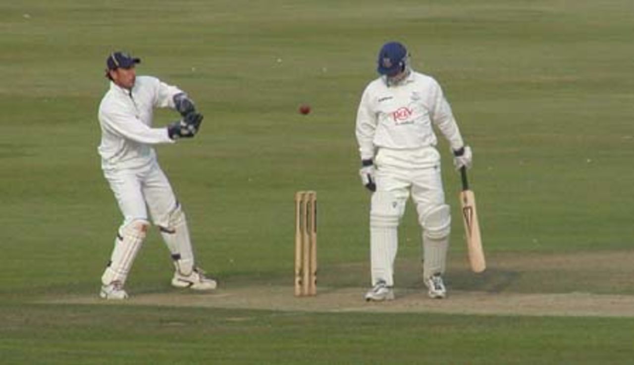 Nic Pothas reaches for the ball as Richard Montgomerie looks on