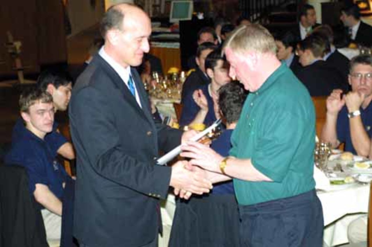 Ian Stuart presents one of three awards won by the Irish Cricket Union in 2002 to Irish Team Manager Brendan O' Brien at the Indoor Championships gala dinner in Denmark