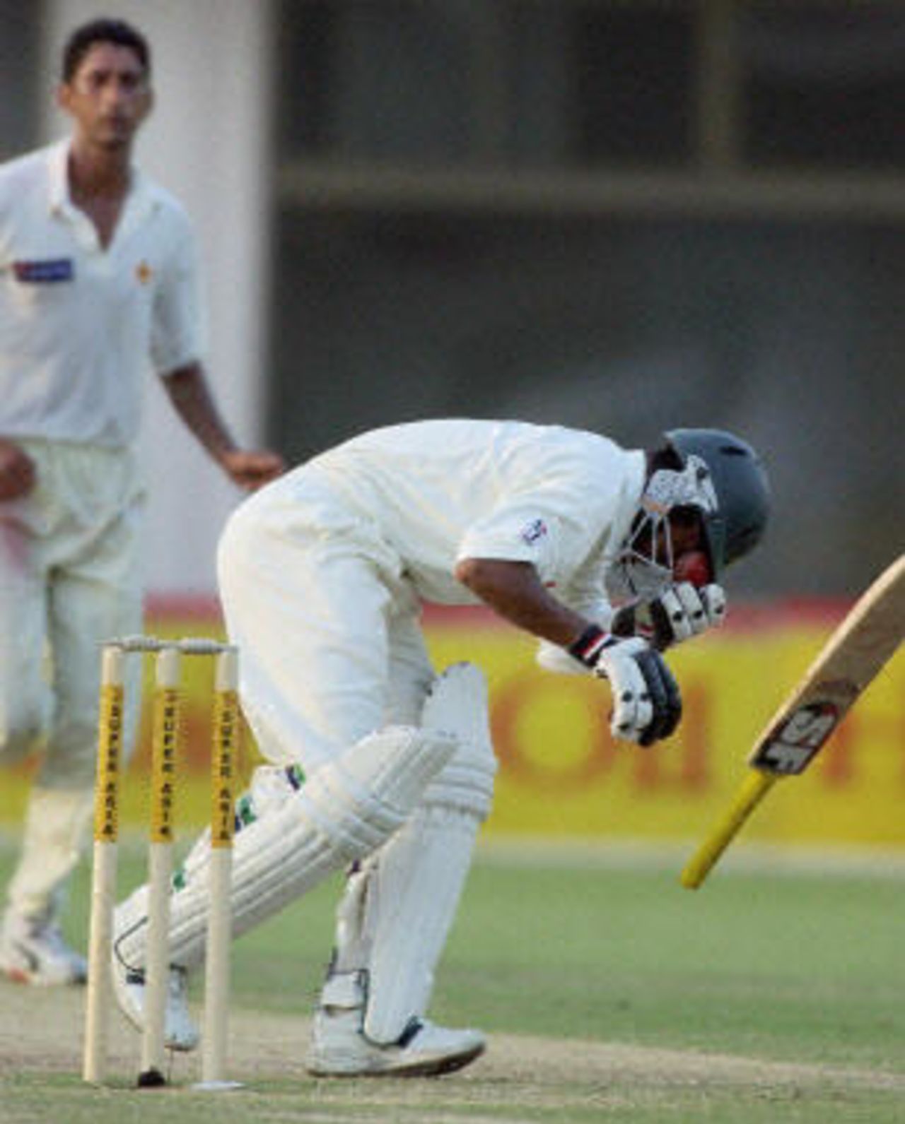 Alok Kapali fall to the ground after a Shabbir Ahmed delivery hit his face, Pakistan v Bangladesh, 3rd Test, Multan, September 4, 2003.