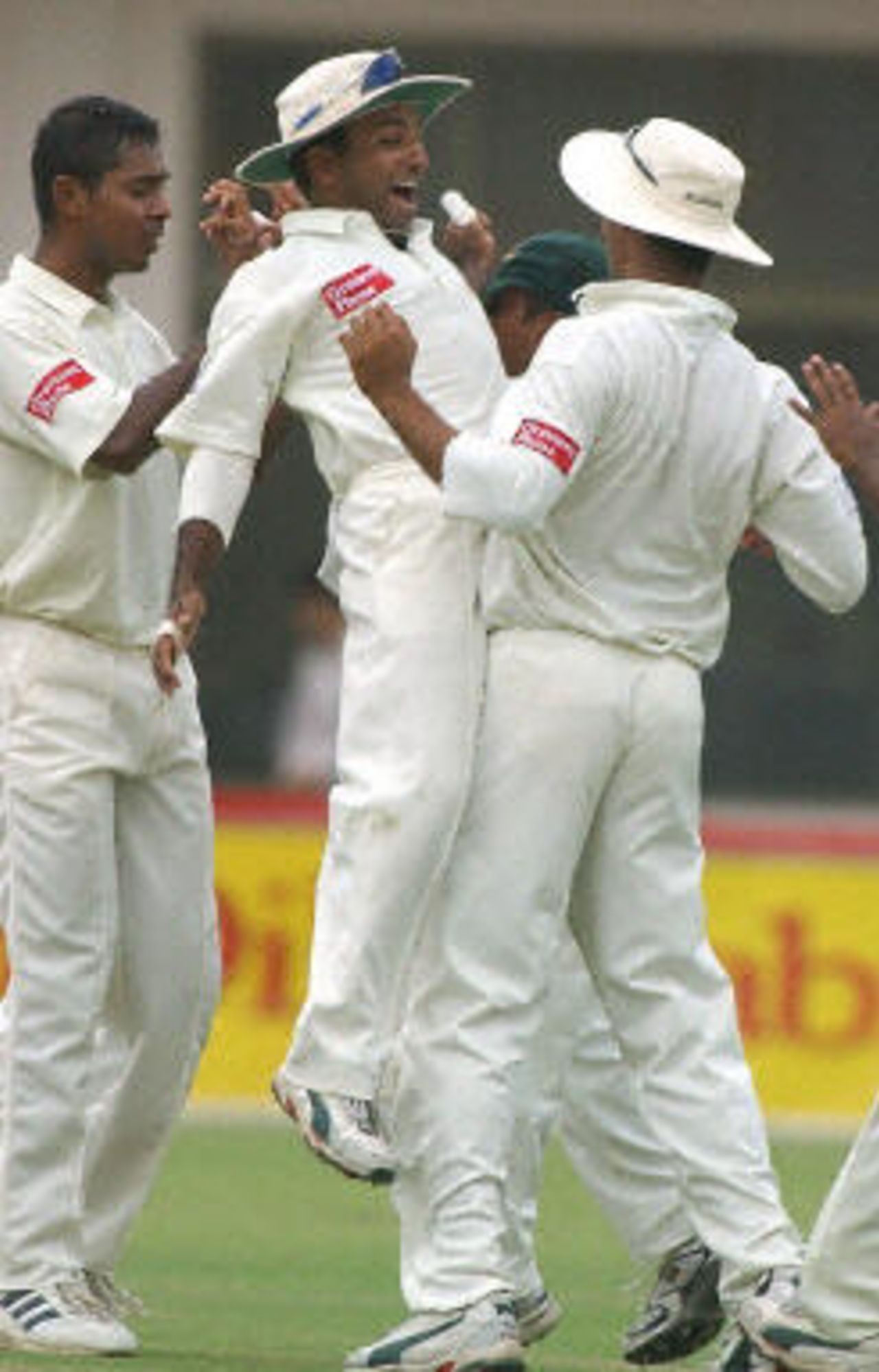 Javed Omar jumps in the air to celebrate with his teammates, Pakistan v Bangladesh, 3rd Test, Multan, September 5, 2003.