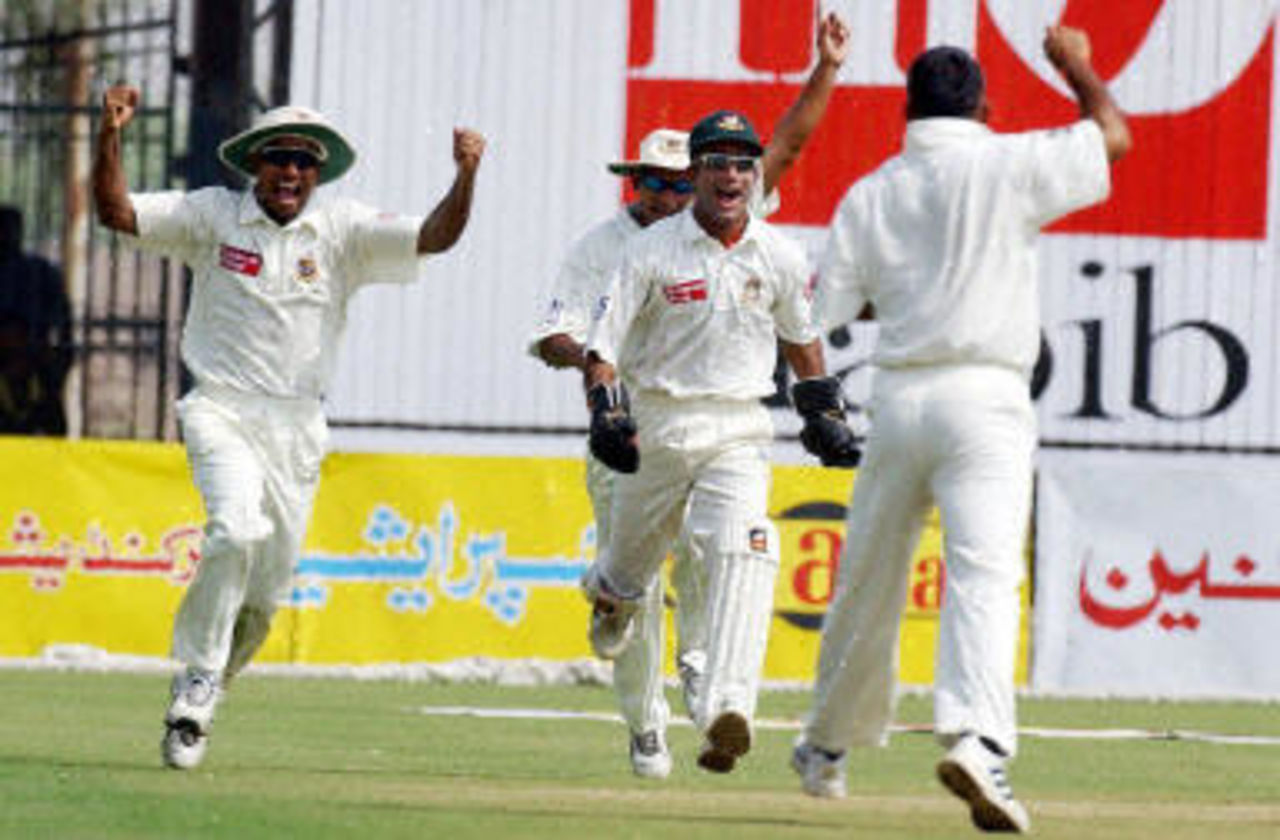 Khaled Mahmud celebrates with teammates after dismissing Saqlain in the morning, Pakistan v Bangladesh, 3rd Test, Multan, September 6, 2003.