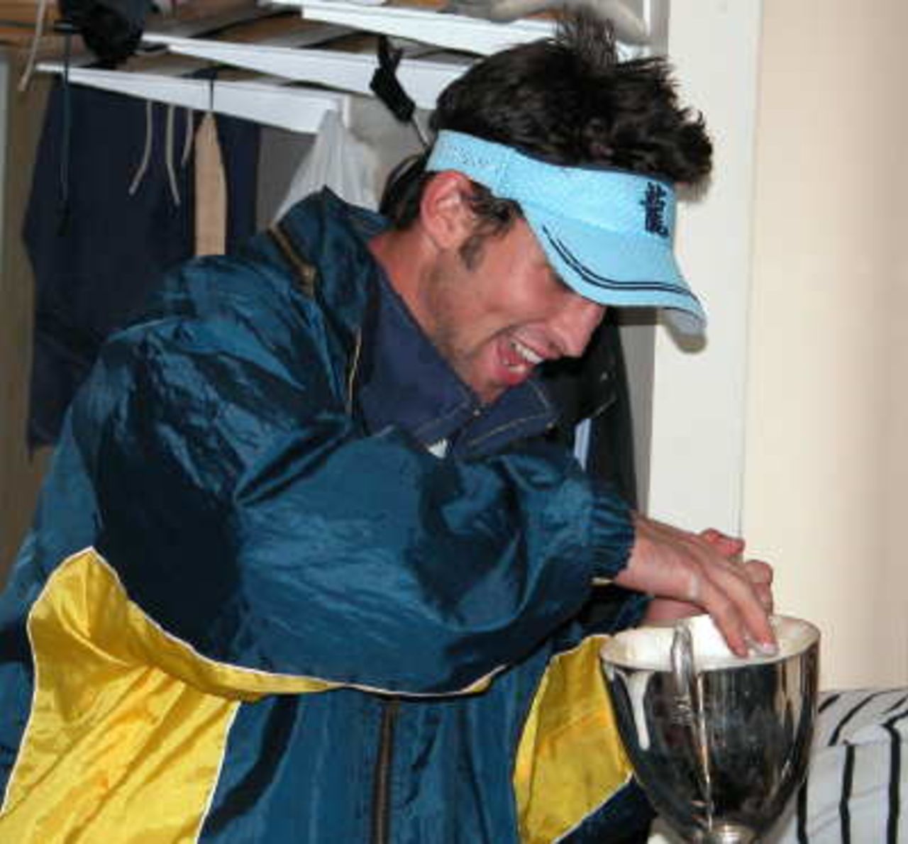 Iain Brunnschweiller takes away the froth from the beer as he prepares his drink.