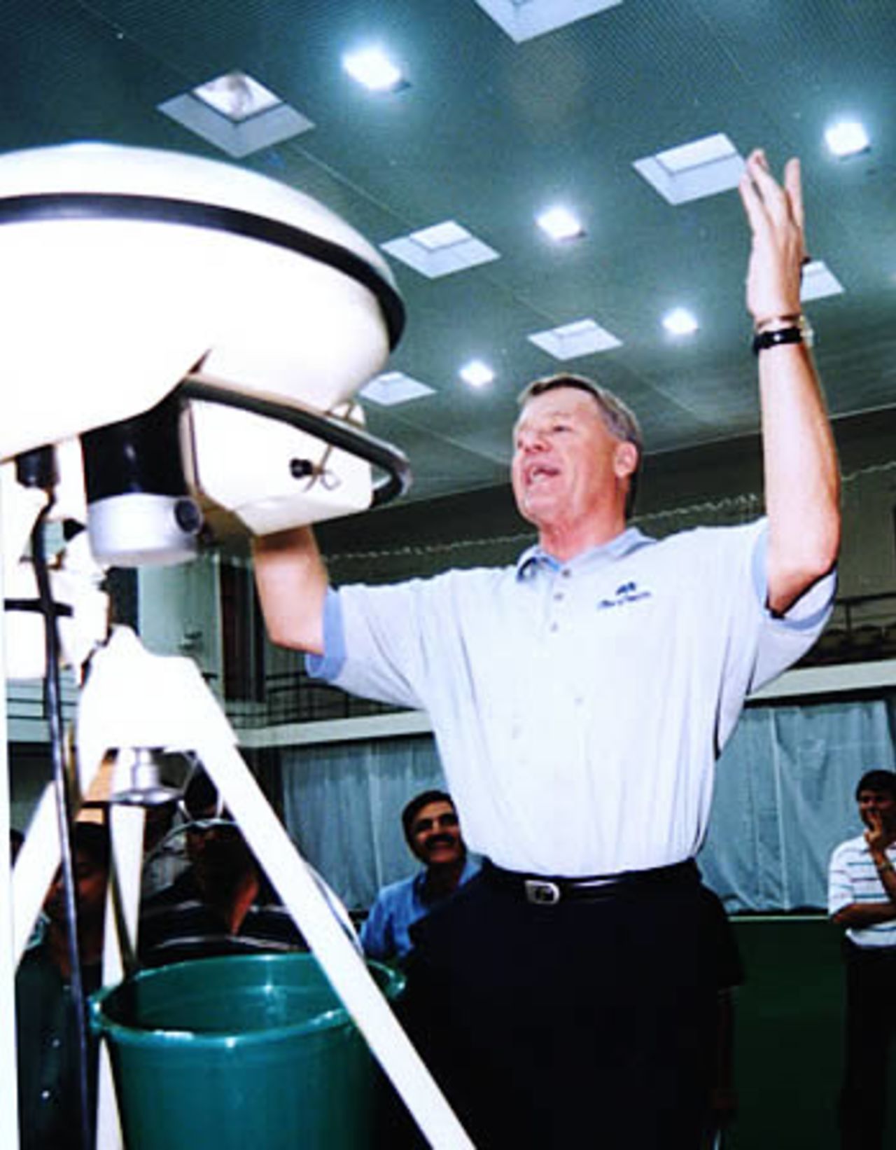 ICC match referee celebrates a clean bowled using a bowling machine at the National Academy, Lahore, September 13, 2003.