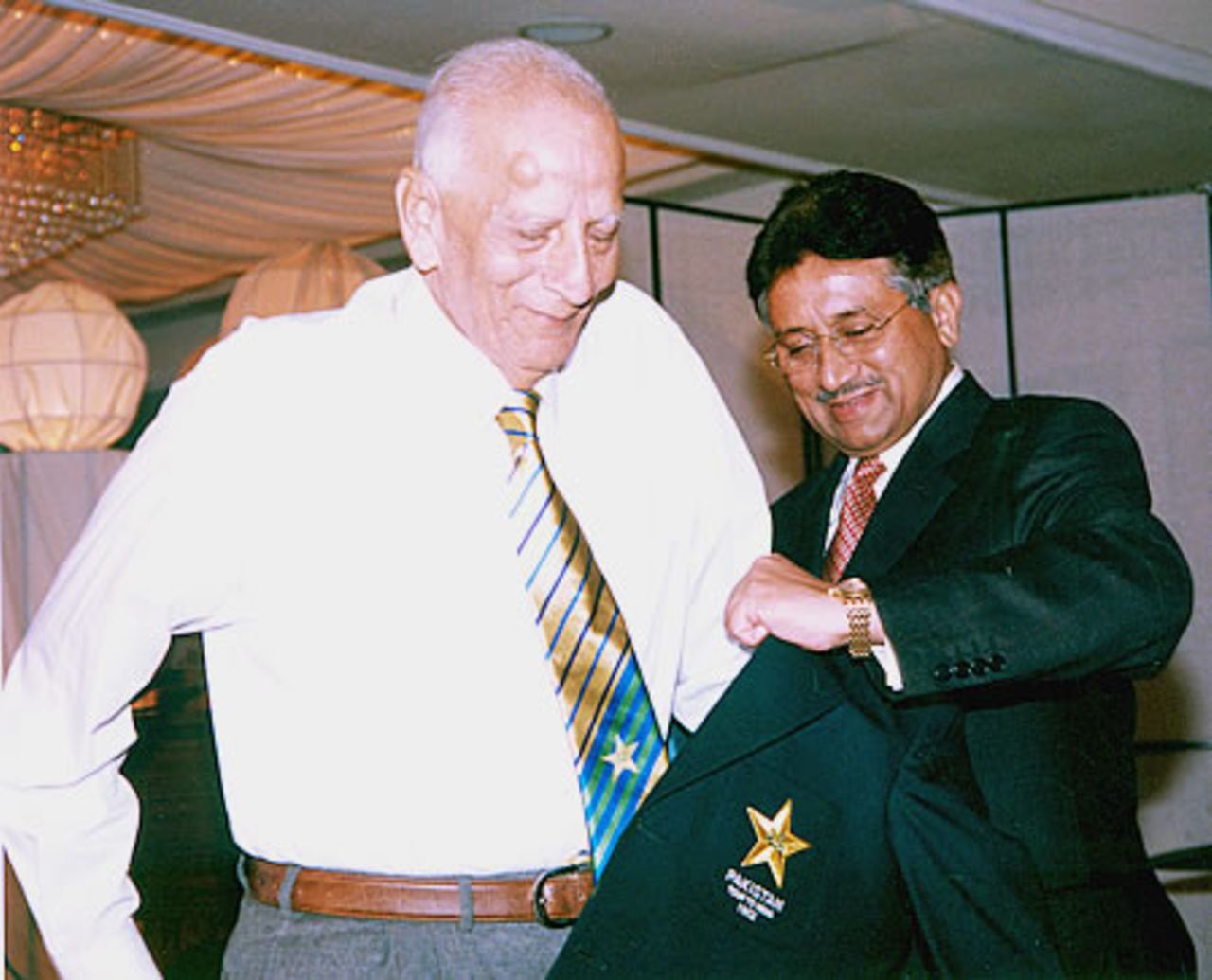 Fazal Mahmood awarded a new Pakistan blazer by Pakistan president during the Golden Jubilee of Test Cricket Gala, Islamabad, September 16, 2003.