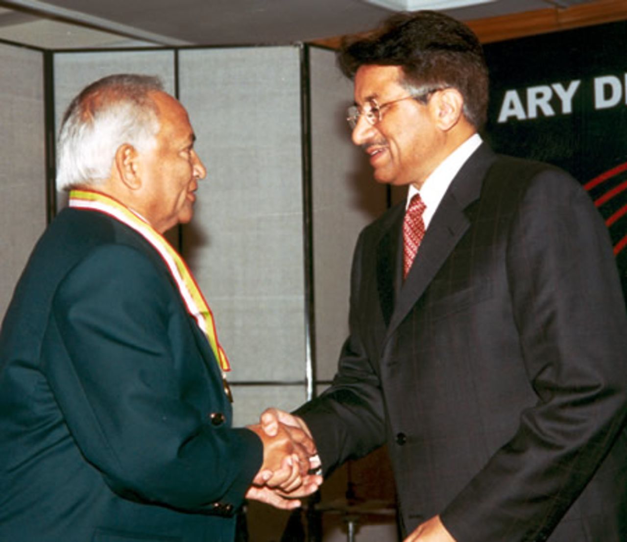 Wazir Mohammad receiving his medal from Pakistan president during the Golden Jubilee of Test Cricket Gala, Islamabad, September 16, 2003.