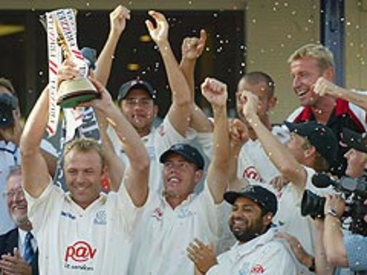 The wait is over: Chris Adams lifts the County Championship trophy for the first time in Sussex's history