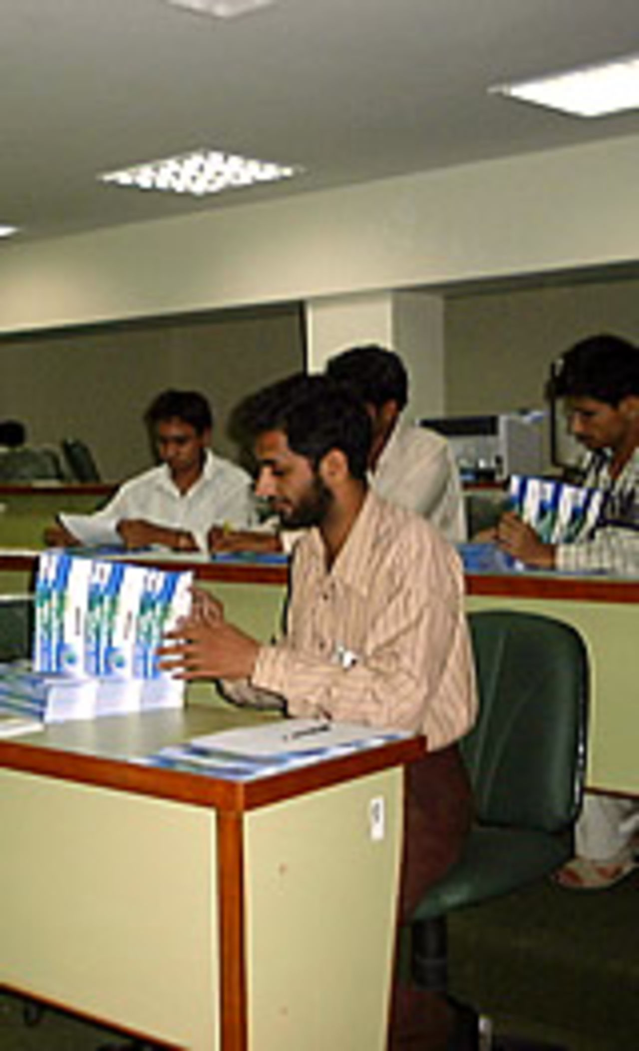 Officials in Pakistan process ticket requests for the Paktel Cup (September 2004)
