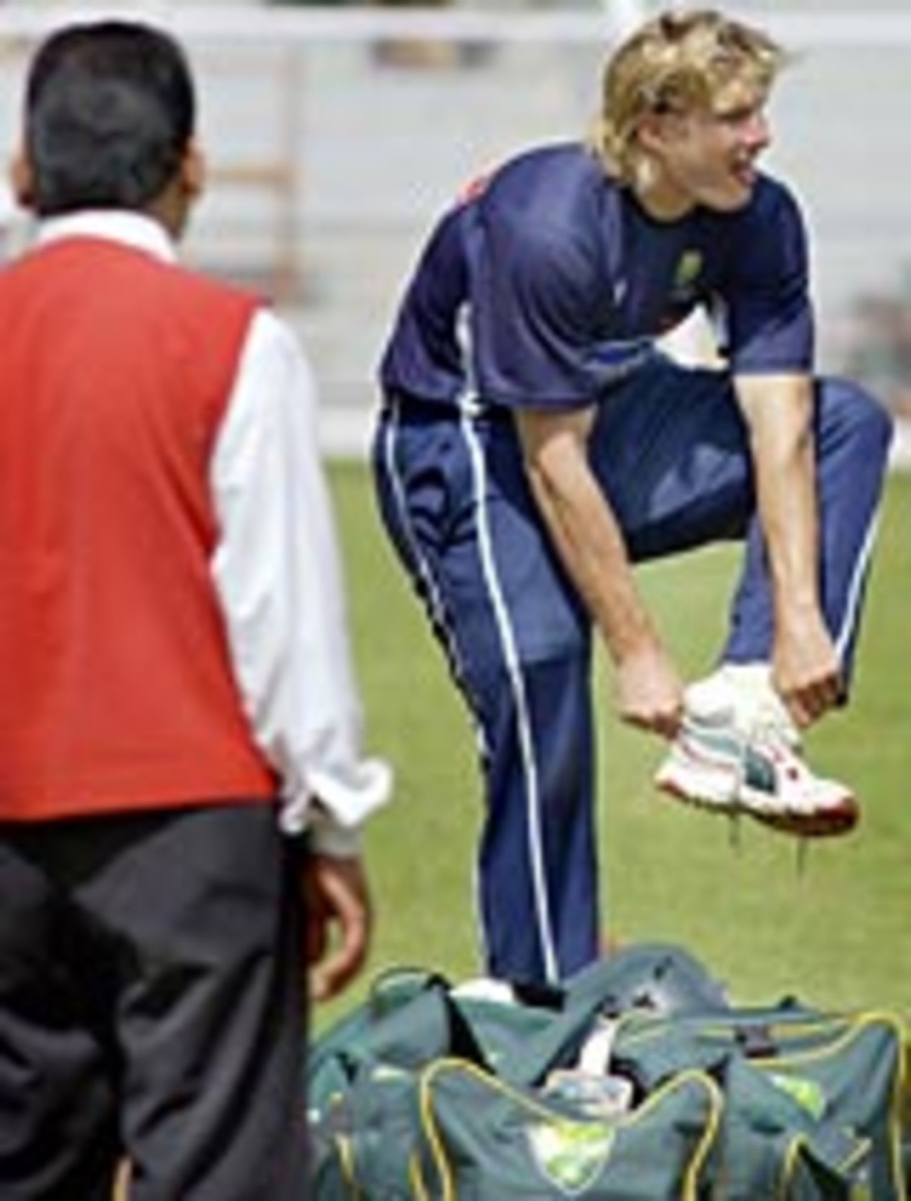 Shane Watson change his shoes during a net session in Mumbai, September 28, 2004.