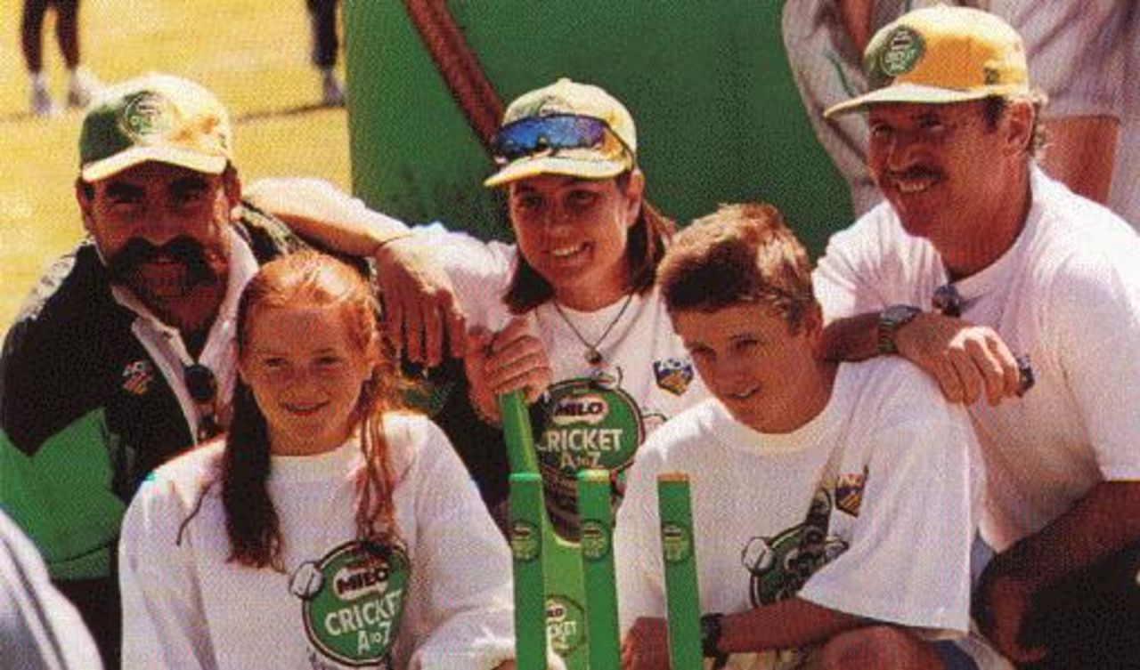 Merv Hughes, Zoe Goss and Allan Border with some Milo Junior Cricketers