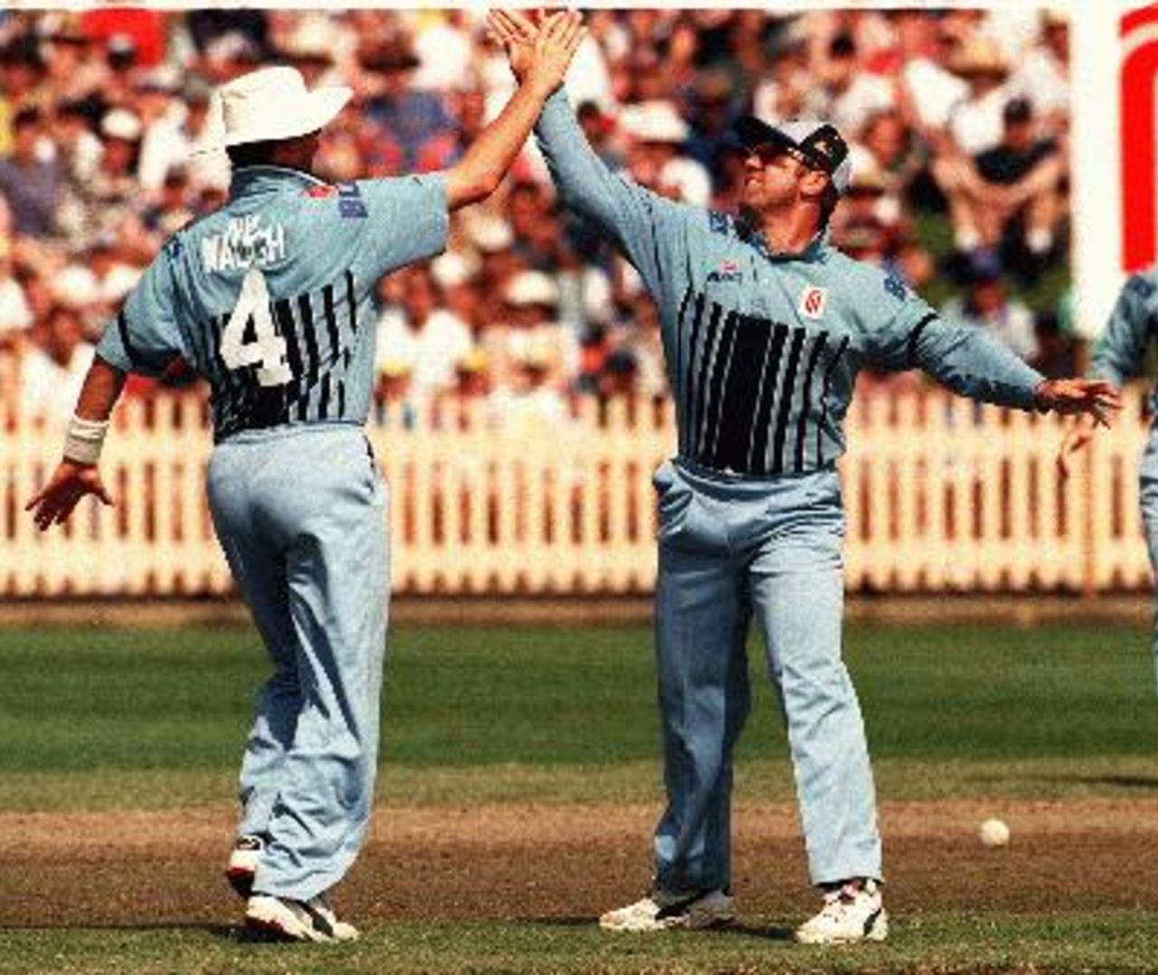 Mark Taylor high fives Mark Waugh after running a Bushranger out during the  Blues v Bushrangers match at The North Sydney Oval, 26 Oct 1997