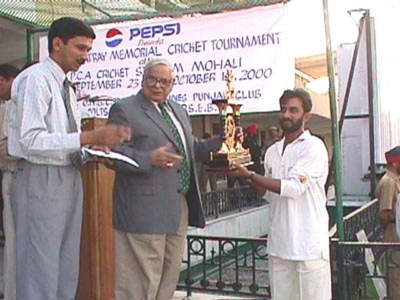 Victorious captain Vikram Rathour receiving the JP Atray Memorial Trophy from Lt General (Retd) JFR Jacob, Governor of Punjab. Vivek Atray, son of the late JP Atray looks on.