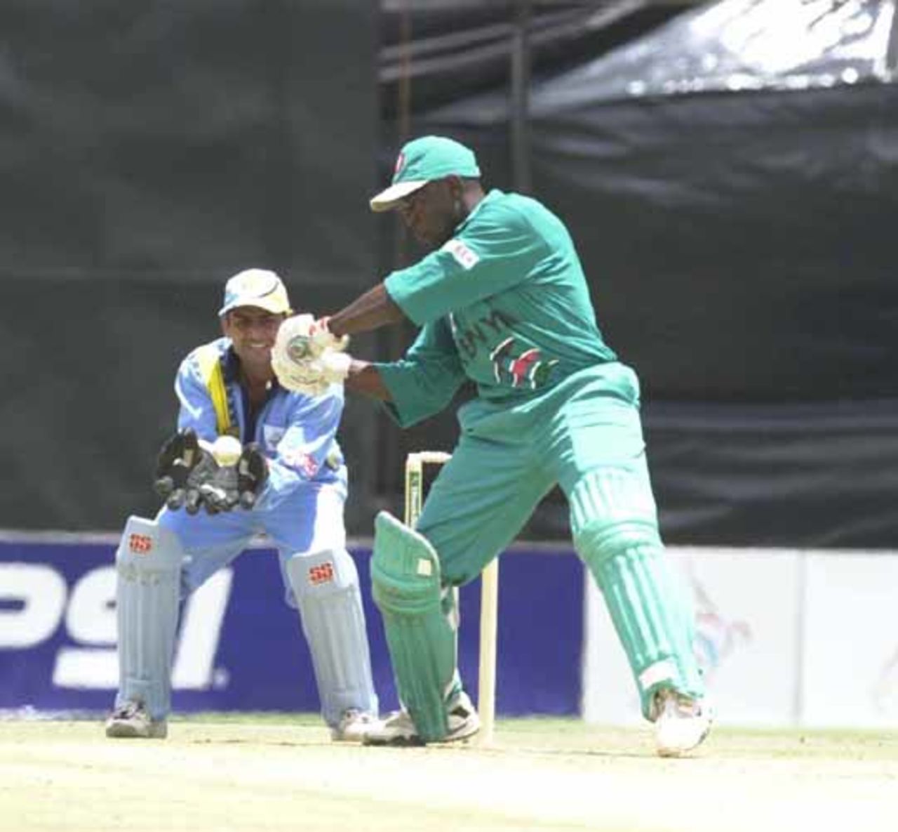 3 Oct 2000: Maurice Odumbe cuts a ball, watched by Vijay Dahiya  during Kenya's ICC KnockOut match against India at Gymkhana Club Ground, Nairobi