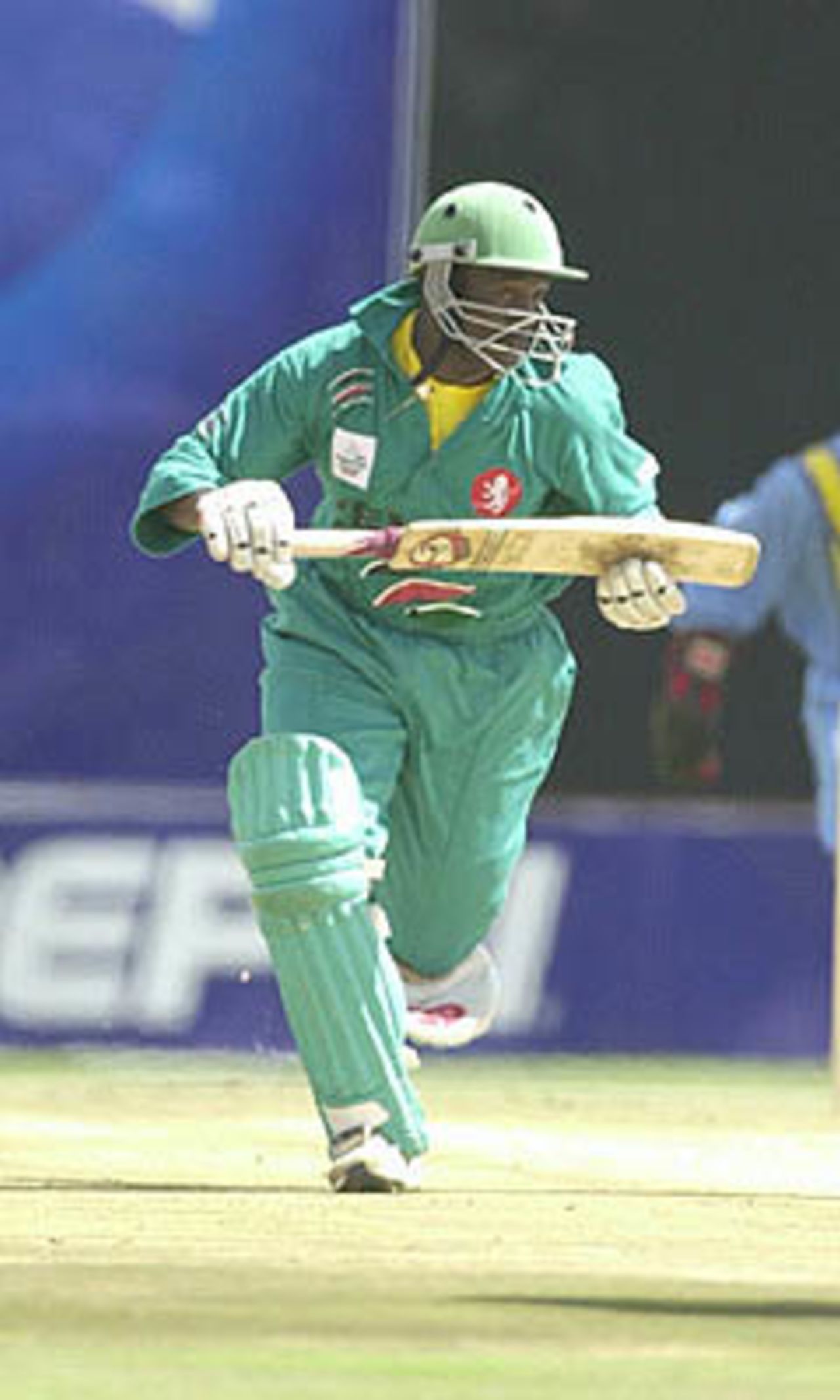 Kenyan batsman Otieno sets off for a run, ICC KnockOut, 2000/01, Preliminary Quarter Final, Kenya v India, Gymkhana Club Ground, Nairobi, 3 October 2000.
