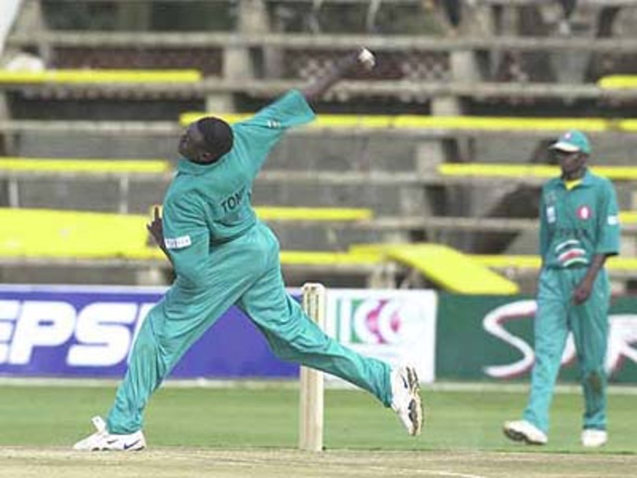 Kenyan opening fast bowler Tony Suji in action against India, ICC KnockOut, 2000/01, Preliminary Quarter Final, Kenya v India, Gymkhana Club Ground, Nairobi, 3 October 2000.