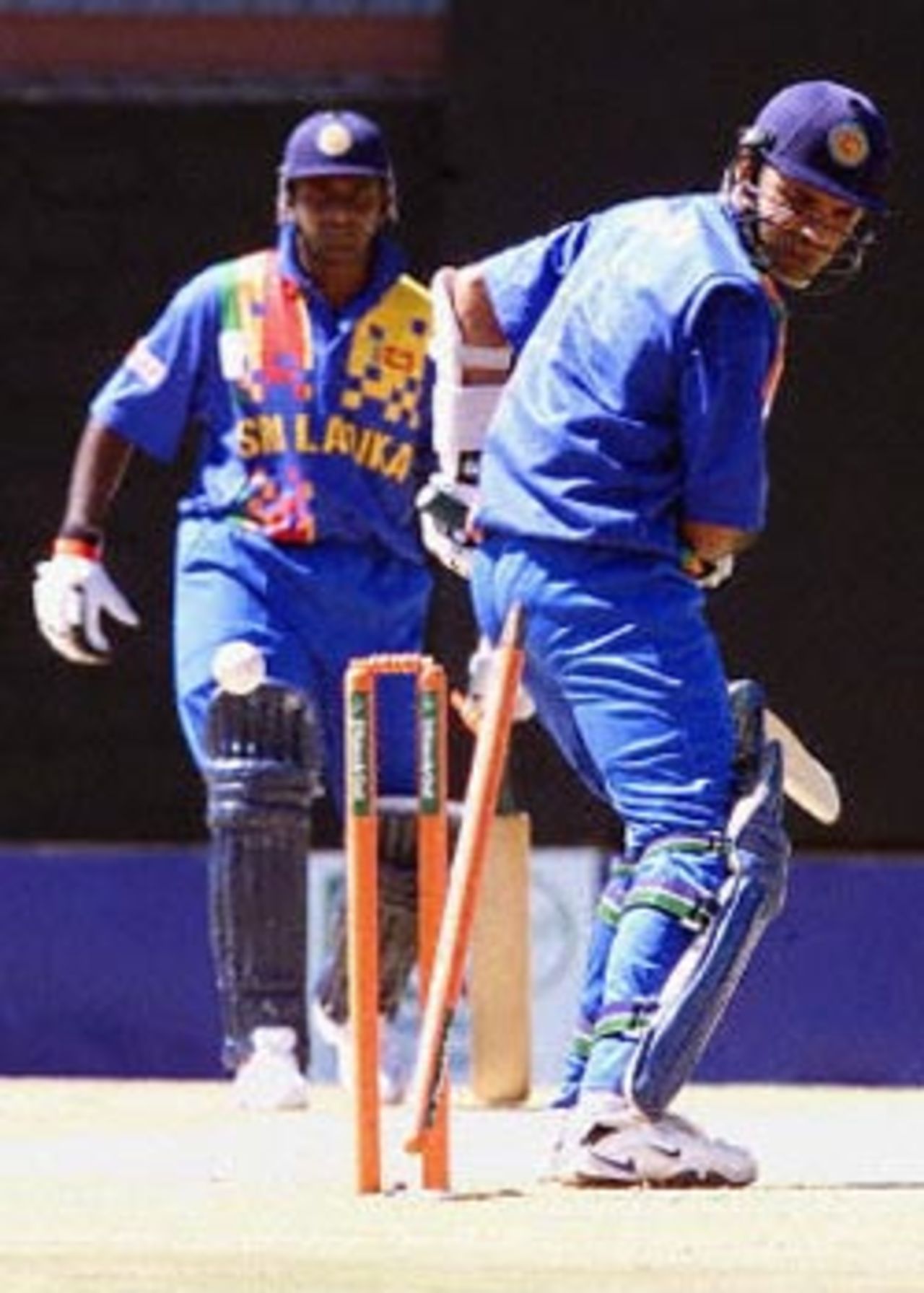 Sri Lanka batsman Marvan Attapatu watches as his stump falls bowled by West Indies fast bowler Mervyn Dillon on the second match of the ICC KnockOut, 2000/01, 2nd Preliminary Quarter Final, Sri Lanka v West Indies, Gymkhana Club Ground, Nairobi, 04 October 2000.