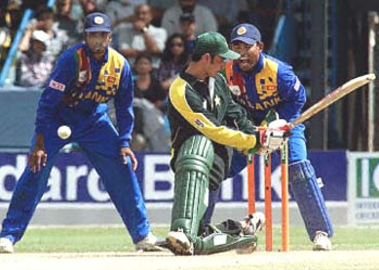 Imran Nazir attempts a sweep shot, Kaluwitharana and Russel Arnold look on. ICC KnockOut 2000/01, 2nd Quarter Final, Pakistan v Sri Lanka Gymkhana Club Ground, Nairobi, 08 Oct 2000