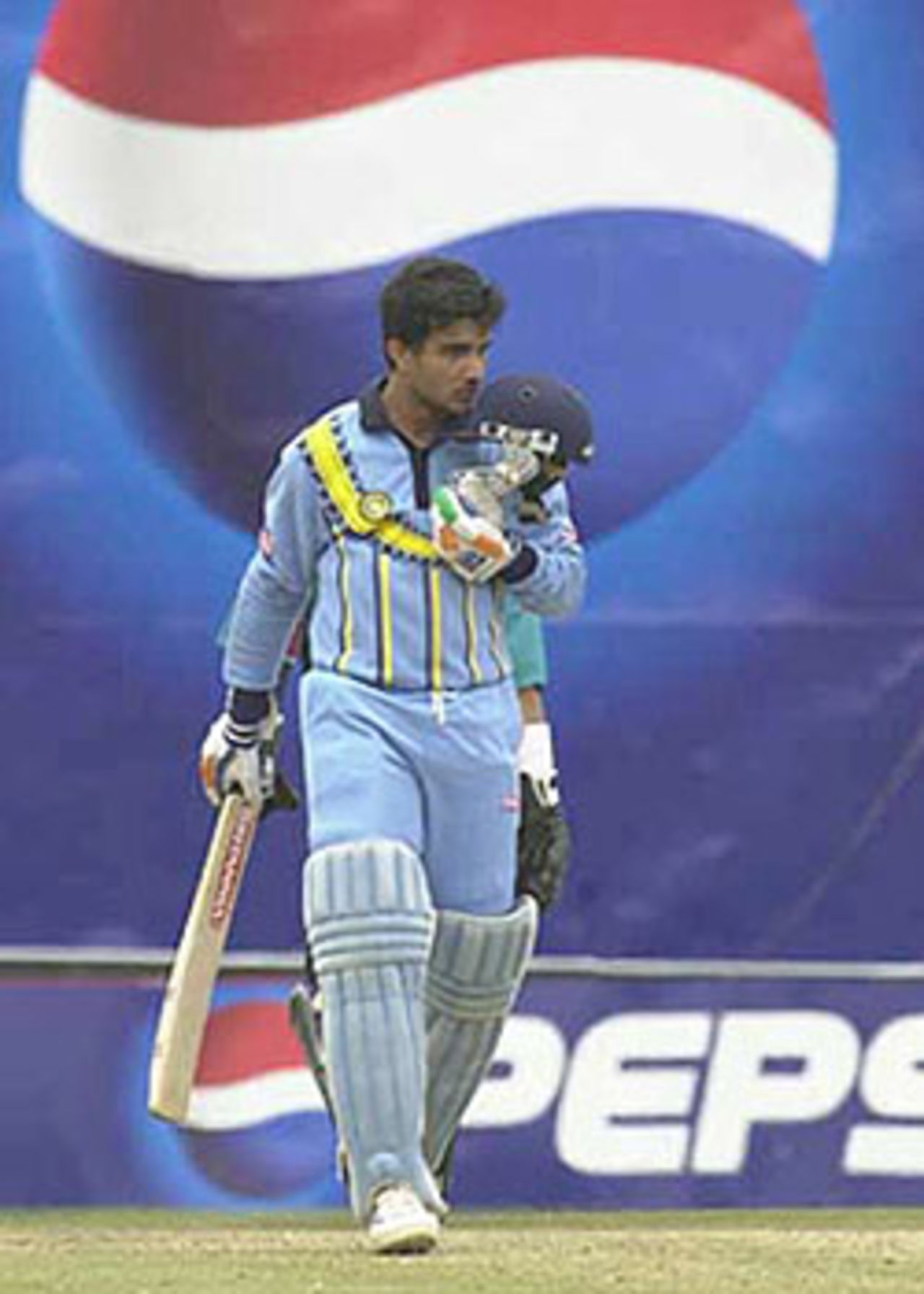 Ganguly kisses the Indian emblem on his helmet on reaching his century, ICC KnockOut, 2000/01, Final, India v New Zealand, Gymkhana Club Ground, Nairobi, 15 October 2000.