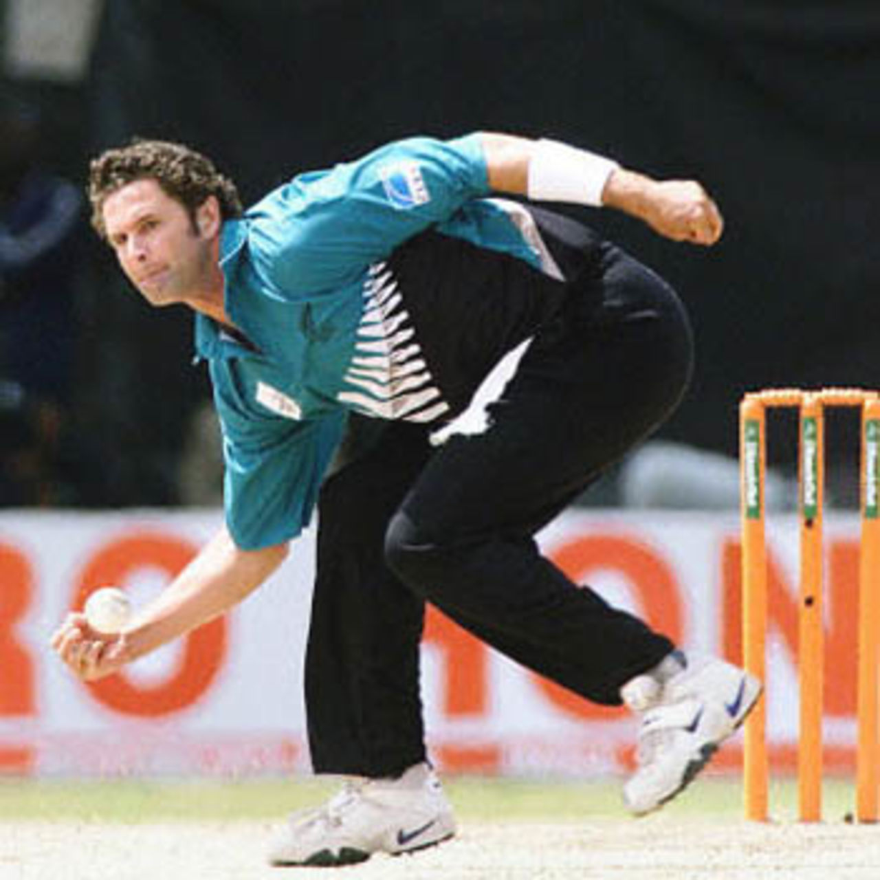 Chris Cairns stops the ball on his follow through, ICC KnockOut, 2000/01, Final, India v New Zealand, Gymkhana Club Ground, Nairobi, 15 October 2000.