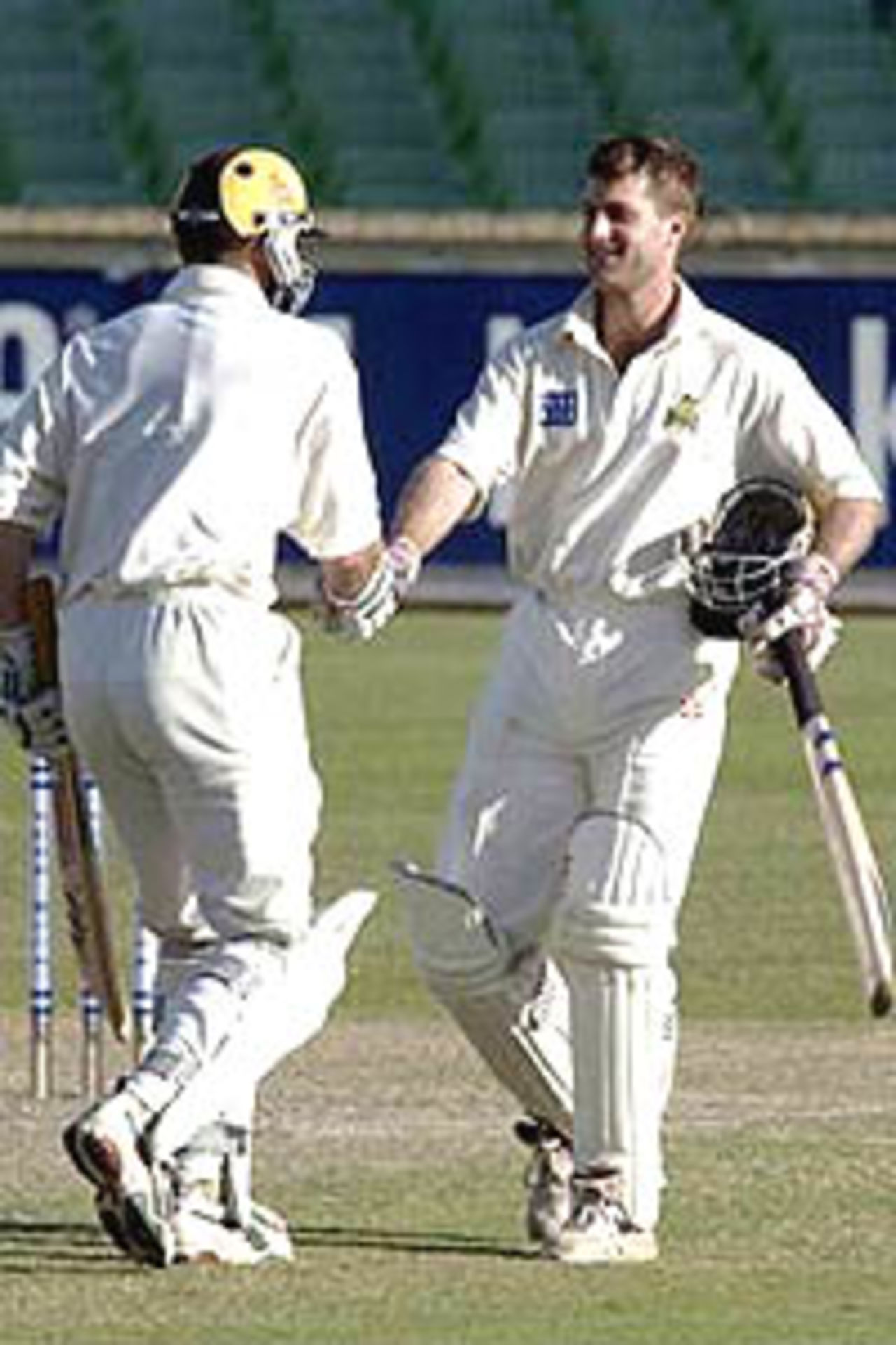 16 Oct 2000: Simon Katich (right) is congratulated by team-mate, Adam Gilchrist for Western Australia after they both made 100 in the Pura Cup during the fourth days play between the Western Australian Warriors and the Queensland Bulls at the WACA ground in Perth Australia.