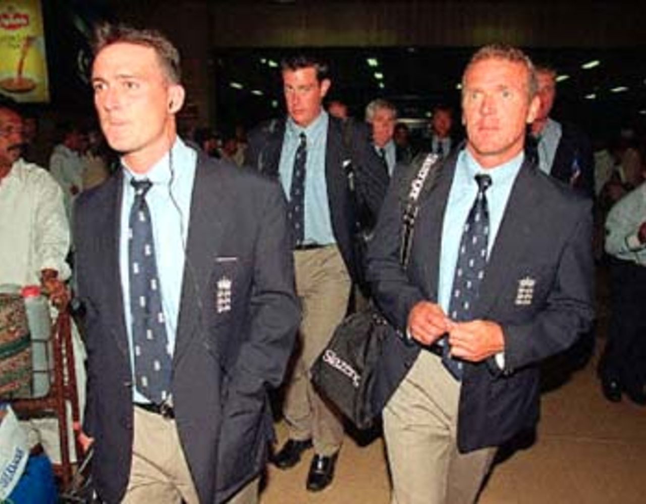 England's Alec Stewart with his team mate walk out of the airport, 16 October 2000