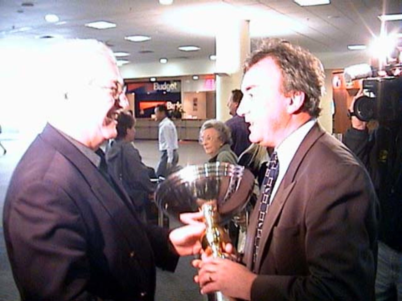 New Zealand Cricket chief executive Christopher Doig hands over the ICC KnockOut trophy to NZC administration manager Tim Murdoch upon arrival at Christchurch International Airport from Nairobi, 18 October 2000