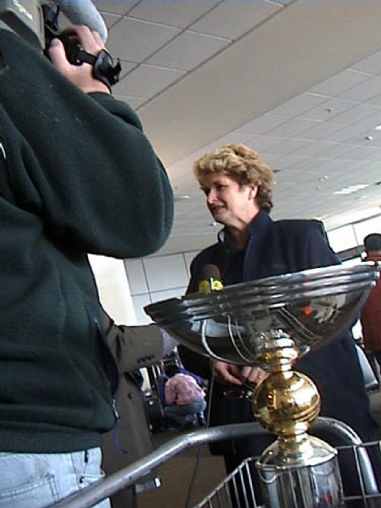 Sue Wilson, mother of Man of the Final Chris Cairns, speaks with television news media at Christchurch International Airport about her son's role in New Zealand's victory over India in the ICC KnockOut final at Nairobi, 18 October 2000