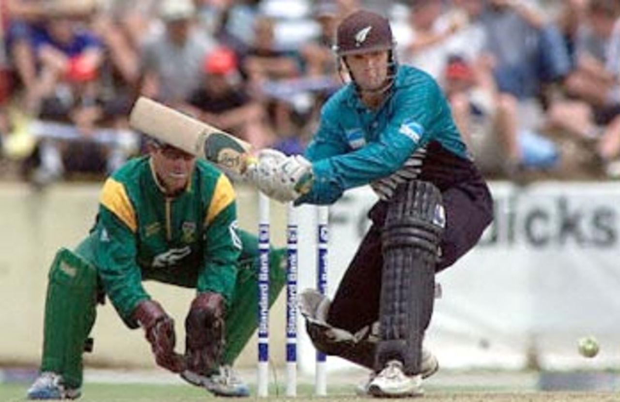 Nathan Astle about to sweep the ball, New Zealand in South Africa 2000/01, 2nd One-Day International, South Africa v New Zealand, Willowmoore Park, Benoni, 22 October 2000.