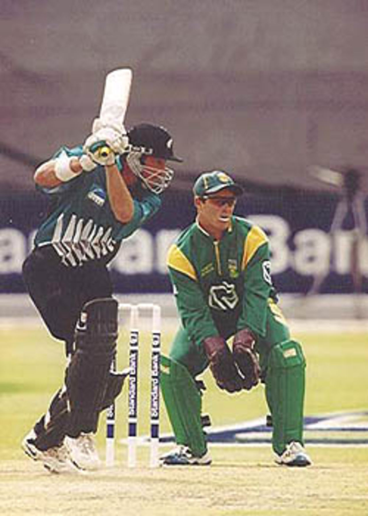 Chris Harris drives as Boucher looks on, New Zealand in South Africa 2000/01, 2nd One-Day International, South Africa v New Zealand, Willowmoore Park, Benoni, 22 October 2000.