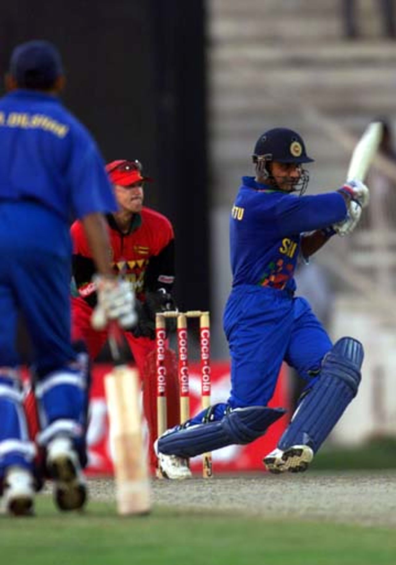 Atapattu drives the ball to the on side while Andy Flower looks at it, Sharjah 25th October 2000
