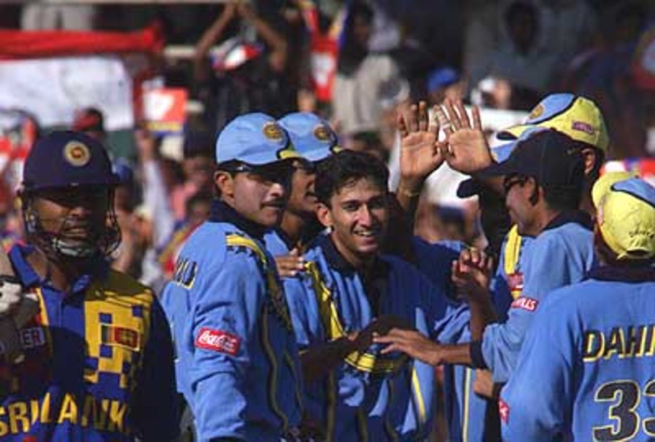 A delighted Agarkar congratulated by teammates as Kaluwitharna walks back, Coca-Cola Champions Trophy, 2000/01, 6th Match, India v Sri Lanka, Sharjah C.A. Stadium, 27 October 2000.
