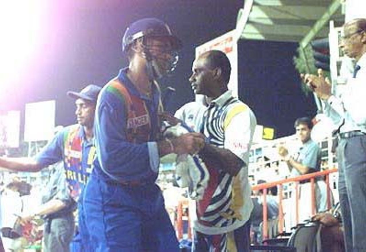 The Lankan skipper gives a pat on the back to Atapattu on his way back, Coca-Cola Champions Trophy, 2000/01, 6th Match, India v Sri Lanka, Sharjah C.A. Stadium, 27 October 2000.