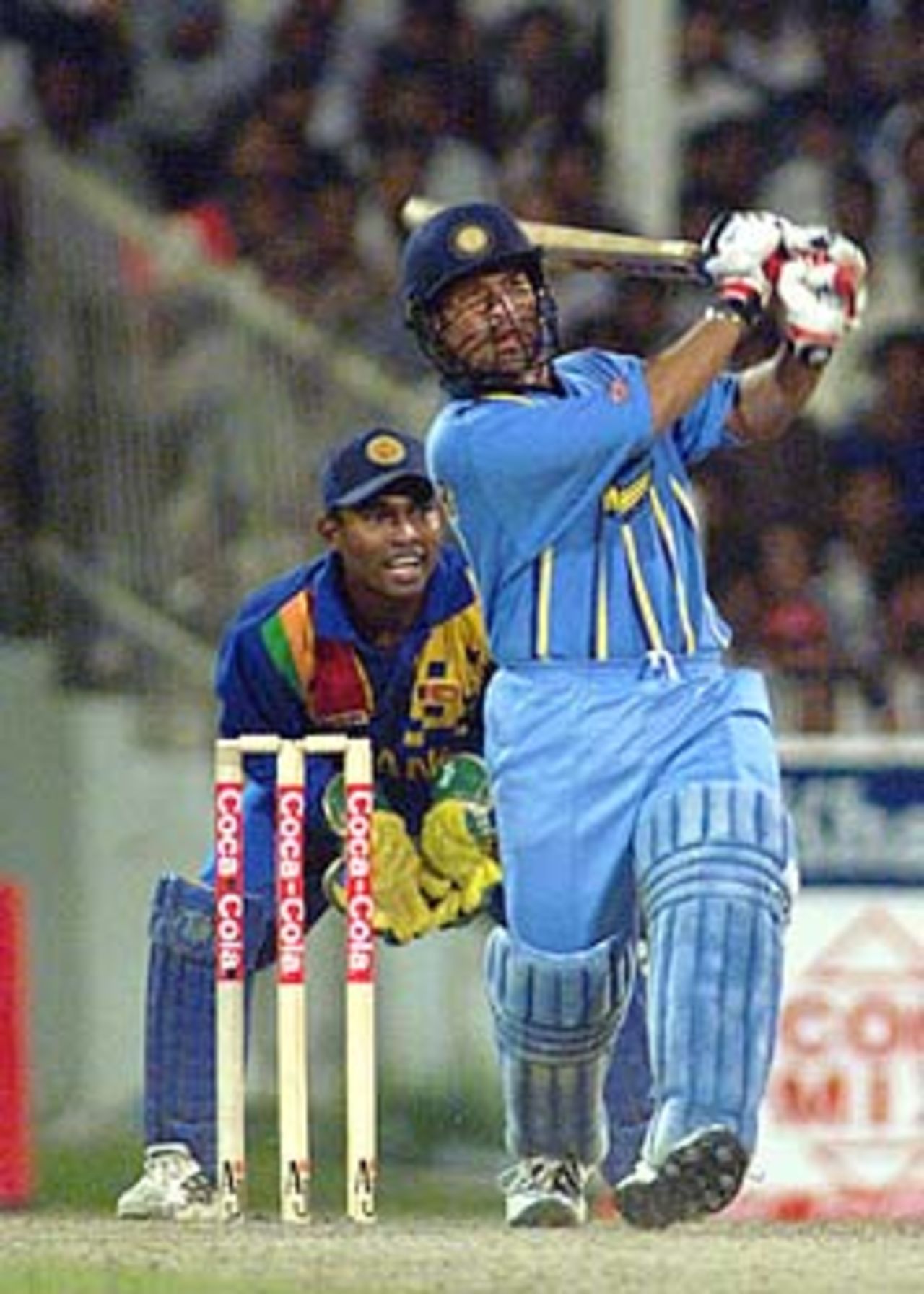 The little master Sachin Tendulkar launches the ball through the onside as stumps Kaluwitharna looks on, Coca-Cola Champions Trophy, 2000/01, 6th Match, India v Sri Lanka, Sharjah C.A. Stadium, 27 October 2000.