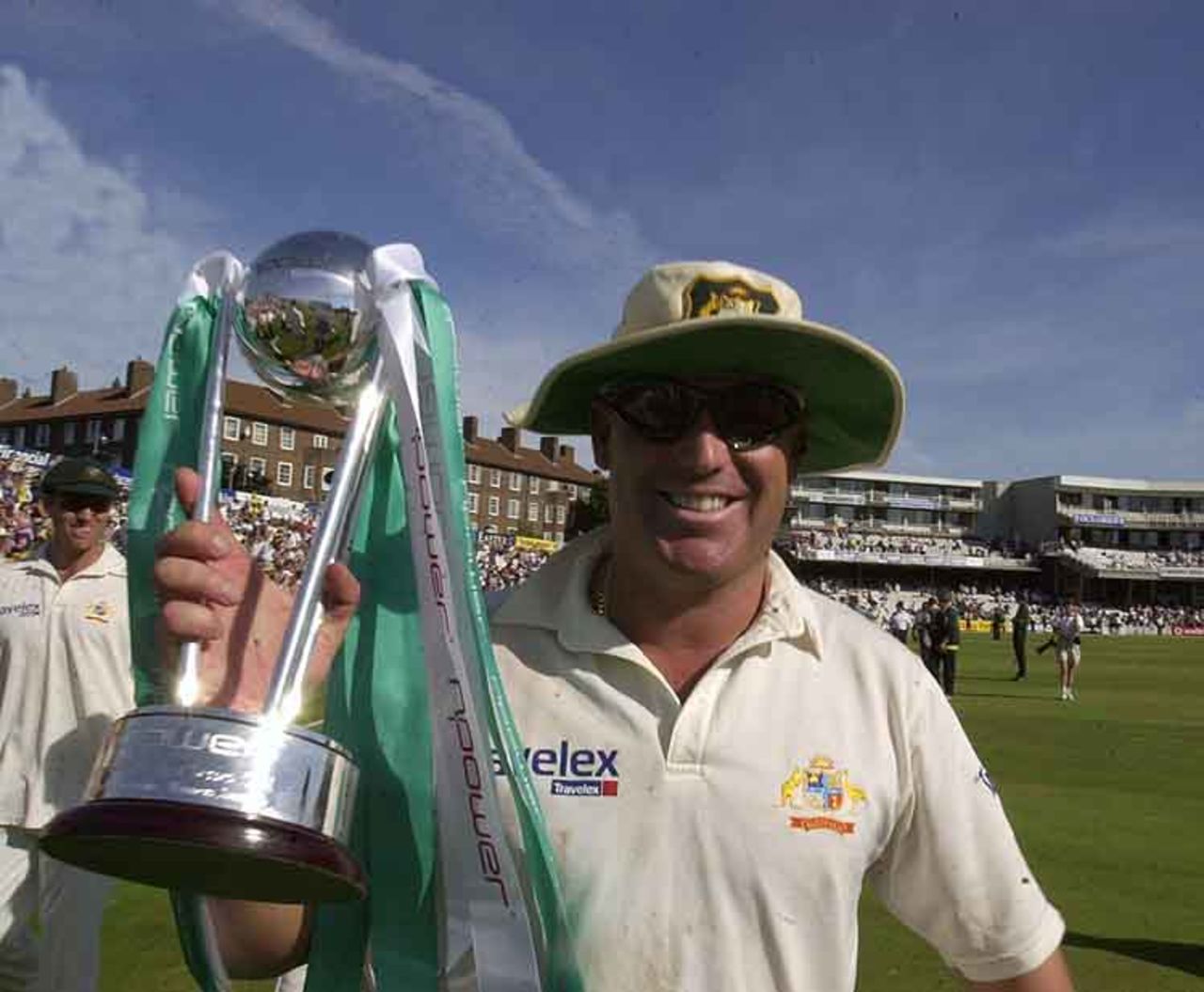 Shane Warne proudly holds the npower Trophy after again mesmerising ...