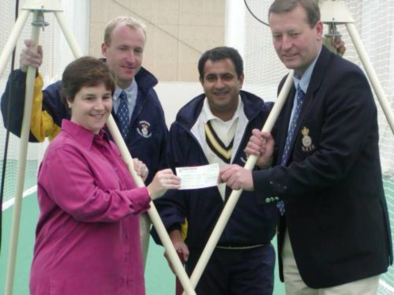 Nicky Batt, Vice Chairman of the HCCC Bournemouth and New Forest Area committee, presents a cheque to Tim Tremlett.  Raj Maru and Will Kendall look on.