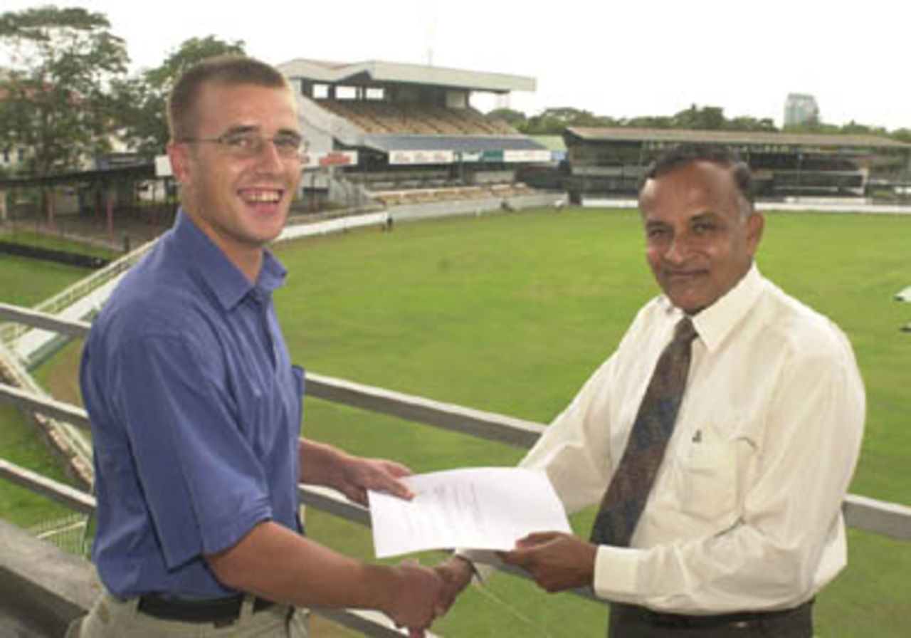 CricInfo's Sri Lankan CEO, Charlie Austin, completes formalities with BCCSL Chief Executive, Anura Tennekoon, at the BCCSL headquarters in Colombo.