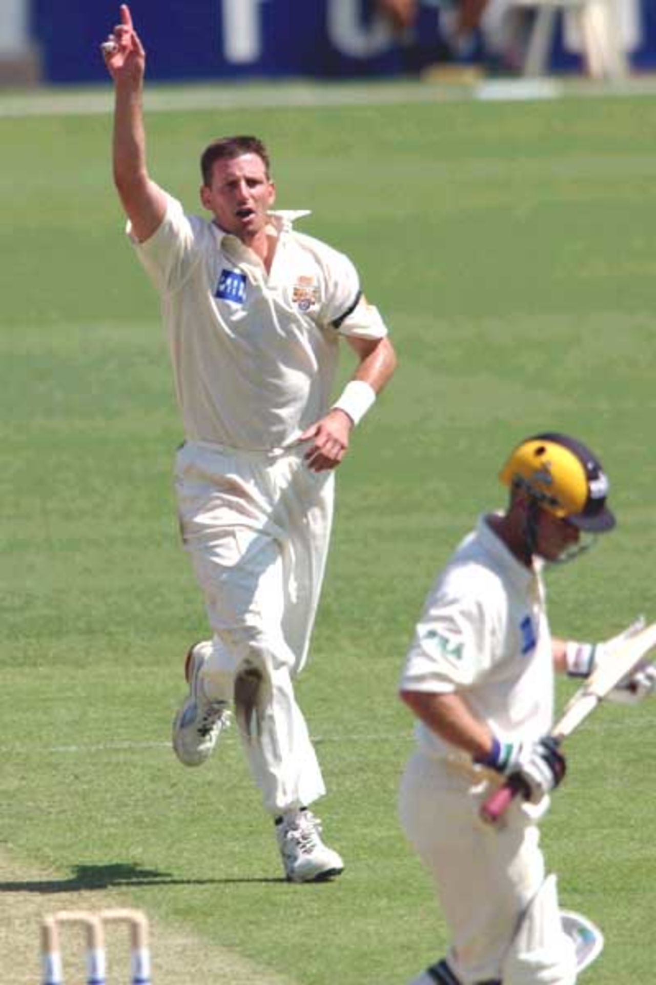 18 Oct 2001: Michael Kasprowicz of Queensland celebrates getting the wicket of Murray Goodwin of Western Australia for 24 runs during the Pura Cup cricket match between Queensland and Western Australia which is being played at the Gabba in Brisbane, Australia.