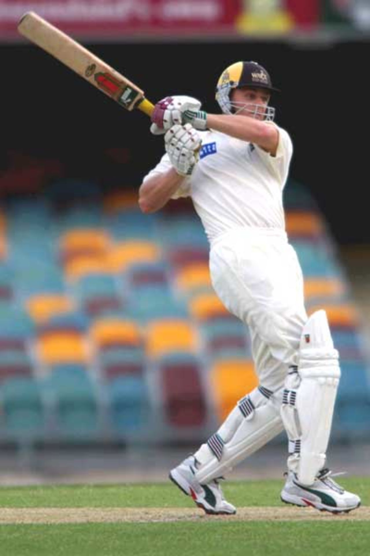18 Oct 2001: Adam Gilchrist of Western Australia hits four runs against Queensland during the Pura Cup cricket match between Queensland and Western Australia which is being played at the Gabba in Brisbane, Australia.