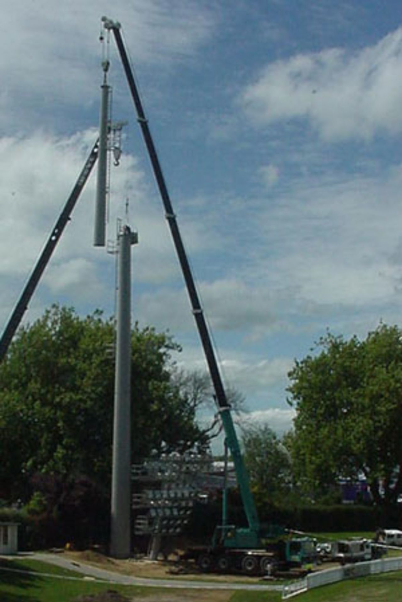 Cranes hoist a section of a new light tower at WestpacTrust Park, Hamilton. 19 October 2001.