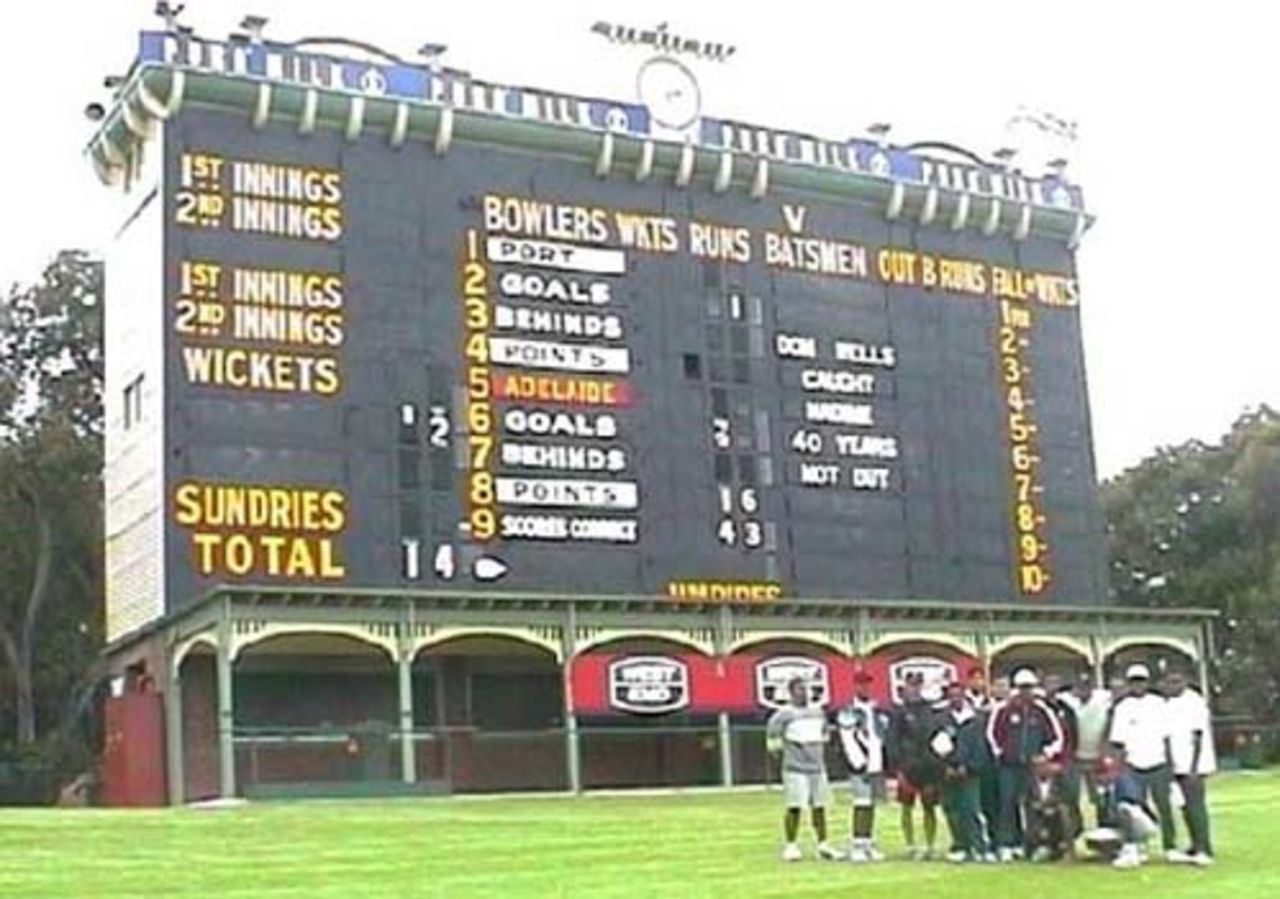 The 15 EAP Cricket Academy attendees in front of the famous Adelaide Oval Scoreboard
