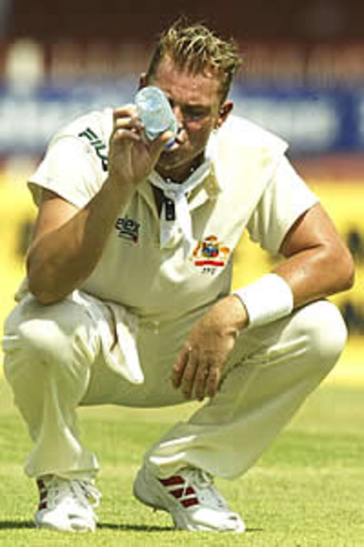 SHARJAH - OCTOBER 11: Shane Warne of Australia feels the heat, during day one of the Second Test between Pakistan and Australia, played at Sharjah International Cricket Stadium, Sharjah, United Arab Emirates on October 11, 2002.