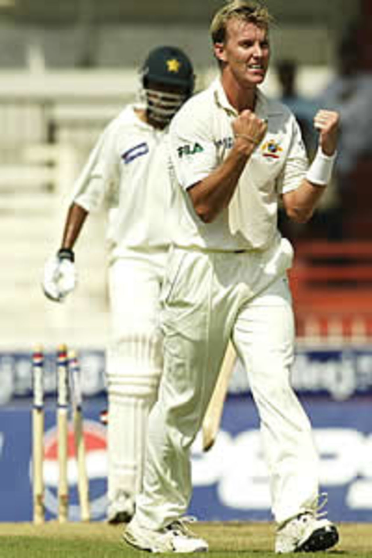 SHARJAH - OCTOBER 11: Brett Lee of Australia celebrates after bowling Danish Kaneria of Pakistan for eight, during day one of the Second Test between Pakistan and Australia, played at Sharjah International Cricket Stadium, Sharjah, United Arab Emirates on October 11, 2002.