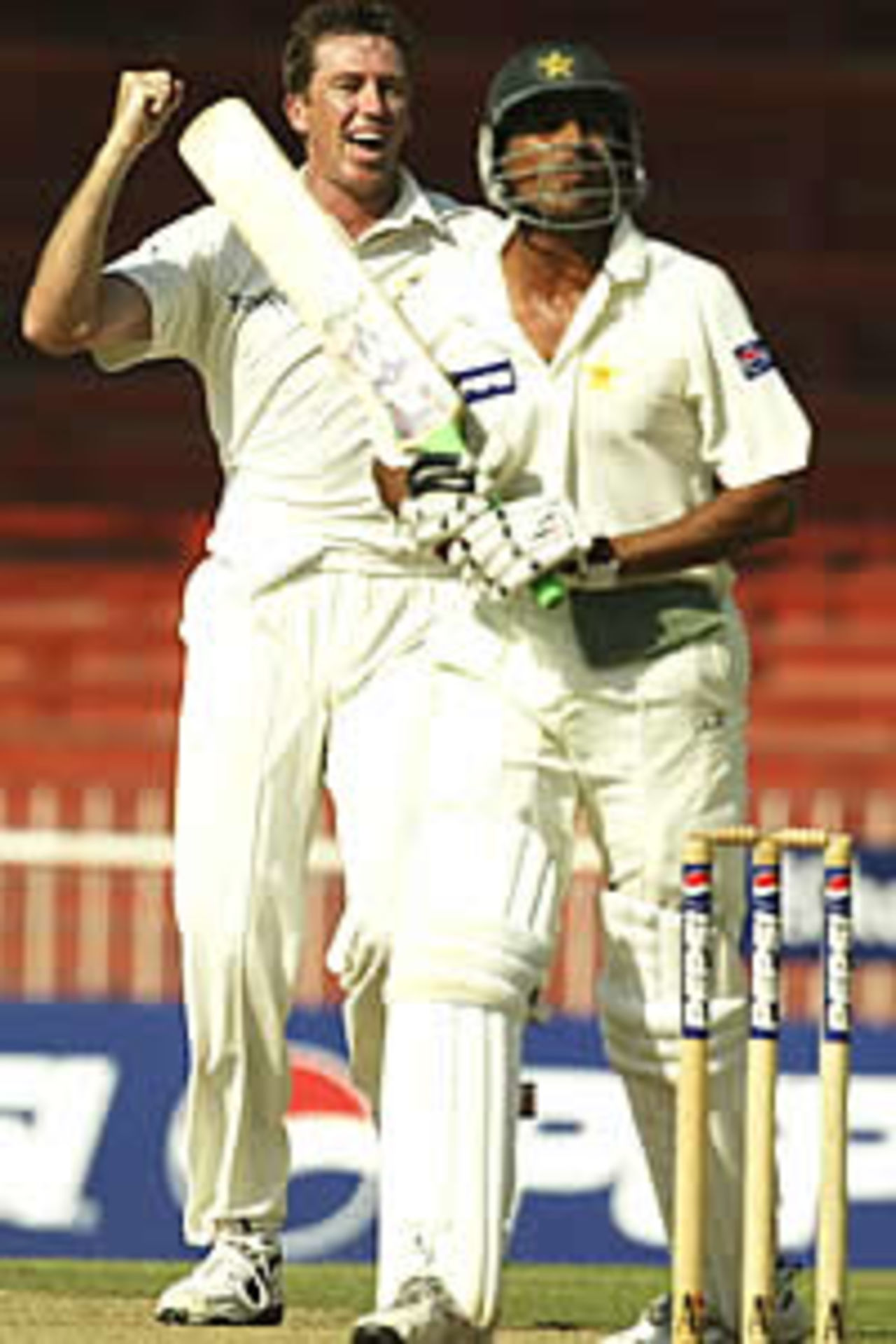 SHARJAH - OCTOBER 12: Glenn McGrath of Australia celebrates after trapping Younis Khan of Pakistan LBW during day two of the Second Test between Pakistan and Australia played at Sharjah International Cricket Stadium in Sharjah, United Arab Emirates on October 12, 2002.